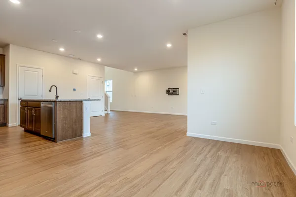a view of a kitchen with a sink and wooden floor