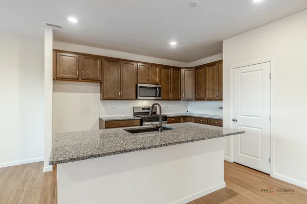 a kitchen with granite countertop wooden cabinets a granite counter tops and a sink