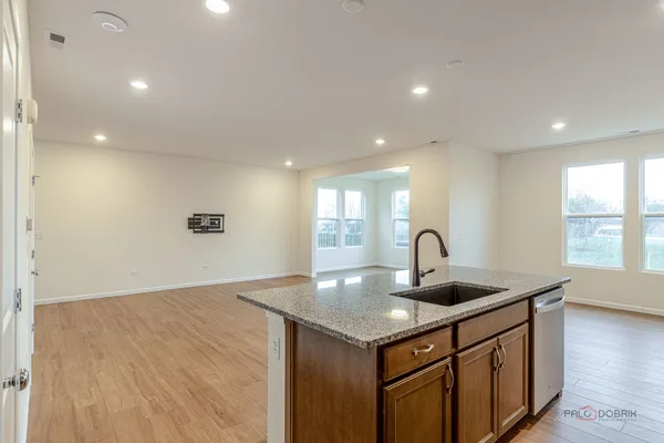 a kitchen with a sink cabinets and wooden floor