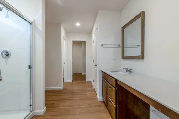 a bathroom with a sink a mirror and a shower