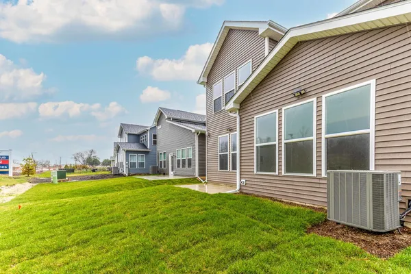 a view of a house with a yard and pathway