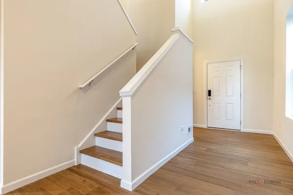 a view of entryway and hall with wooden floor