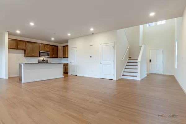 a view of kitchen with wooden floor and electronic appliances