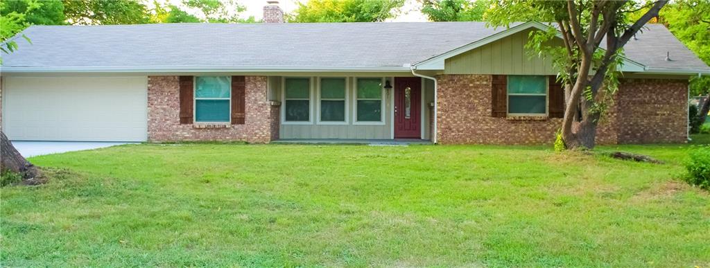 a view of a house with a yard and tree