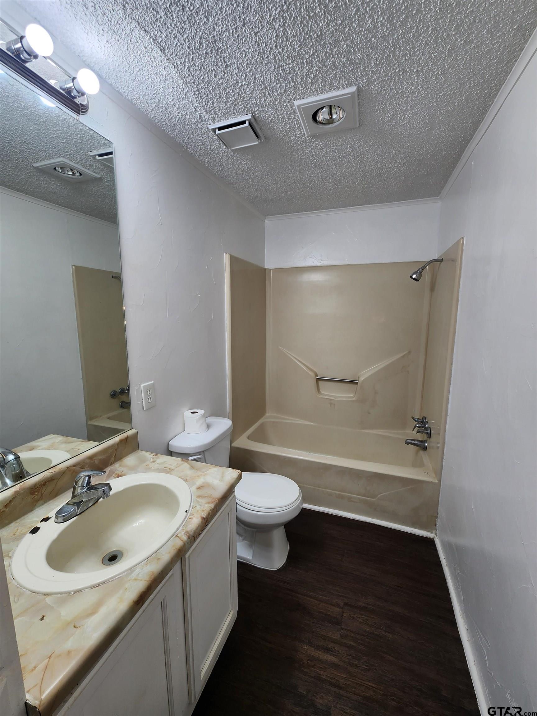 7679 Lindy Lane Frankston, TX 75763 - Photo 13 of 21 a bathroom with a sink a toilet and shower