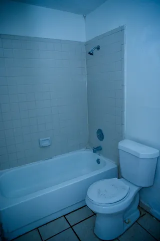 an empty room with a window and a ceiling fan