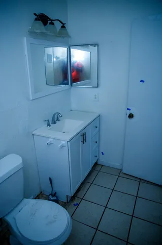 a bathroom with a sink a toilet and mirror