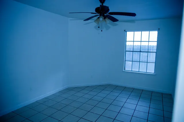a view of an empty room and a window