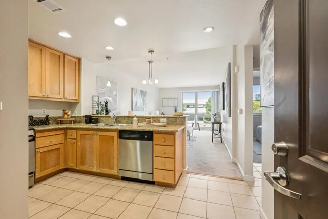 a kitchen with stainless steel appliances granite countertop a sink and cabinets