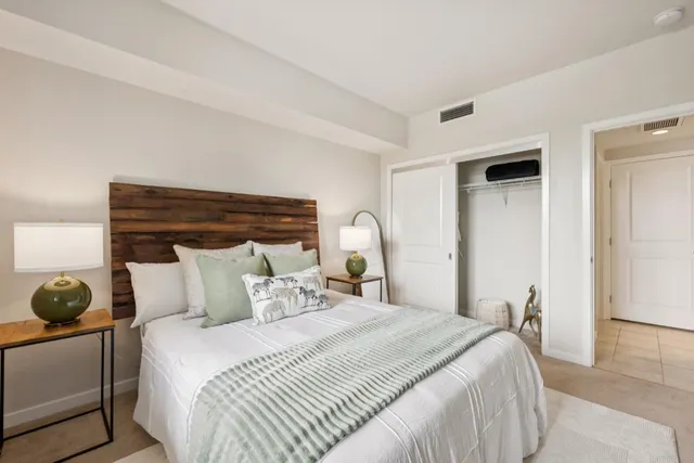 a bedroom with a bed and a window