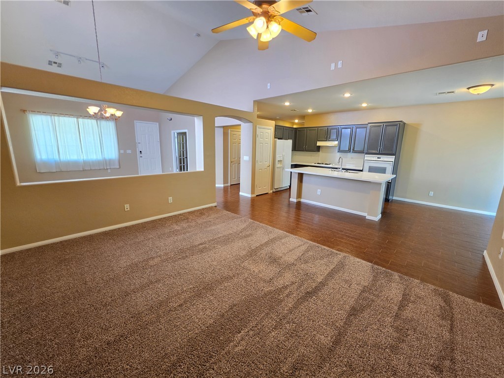 209 Opera House Street Henderson, NV 89012 - Photo 10 of 45 Vaulted ceilings and wood-look flooring enhance the open flow of this central living area.