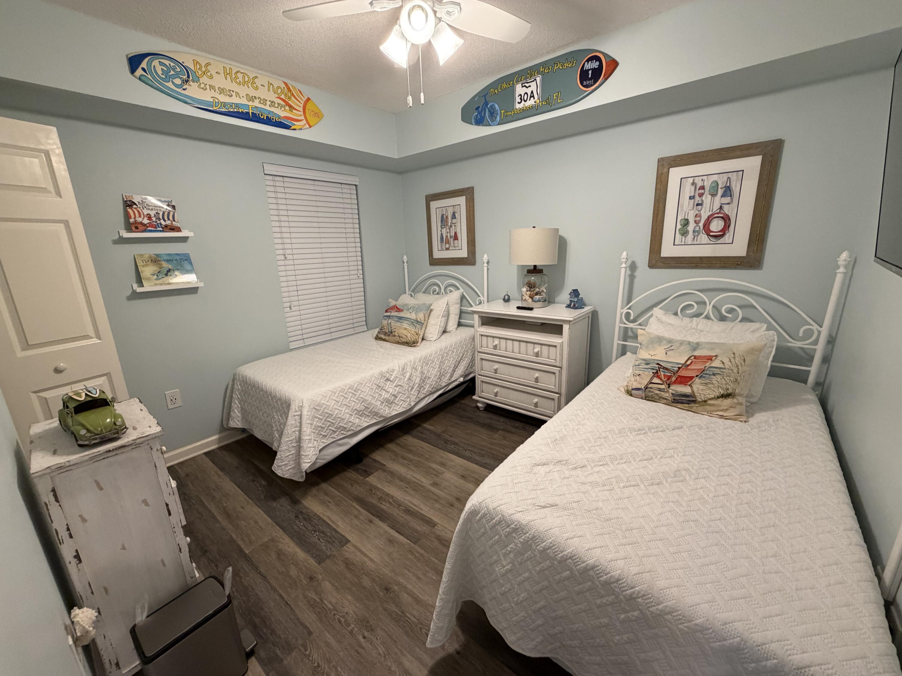 970 Highway 98, Unit 301 Destin, FL 32541 - Photo 11 of 18 a bedroom with two beds and a lamp on the dresser