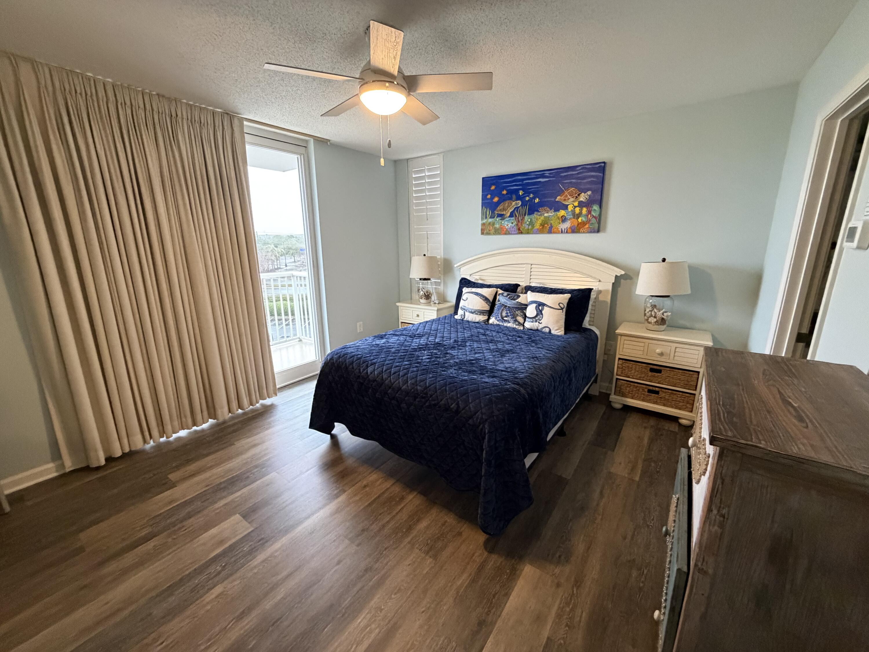 970 Highway 98, Unit 301 Destin, FL 32541 - Photo 12 of 18 a bedroom with a bed and a chandelier
