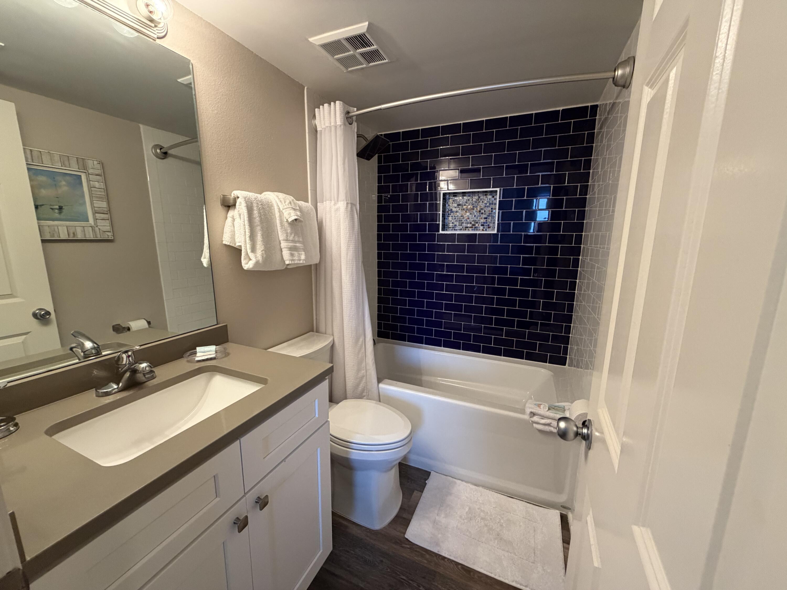 970 Highway 98, Unit 301 Destin, FL 32541 - Photo 13 of 18 a bathroom with a sink toilet and shower