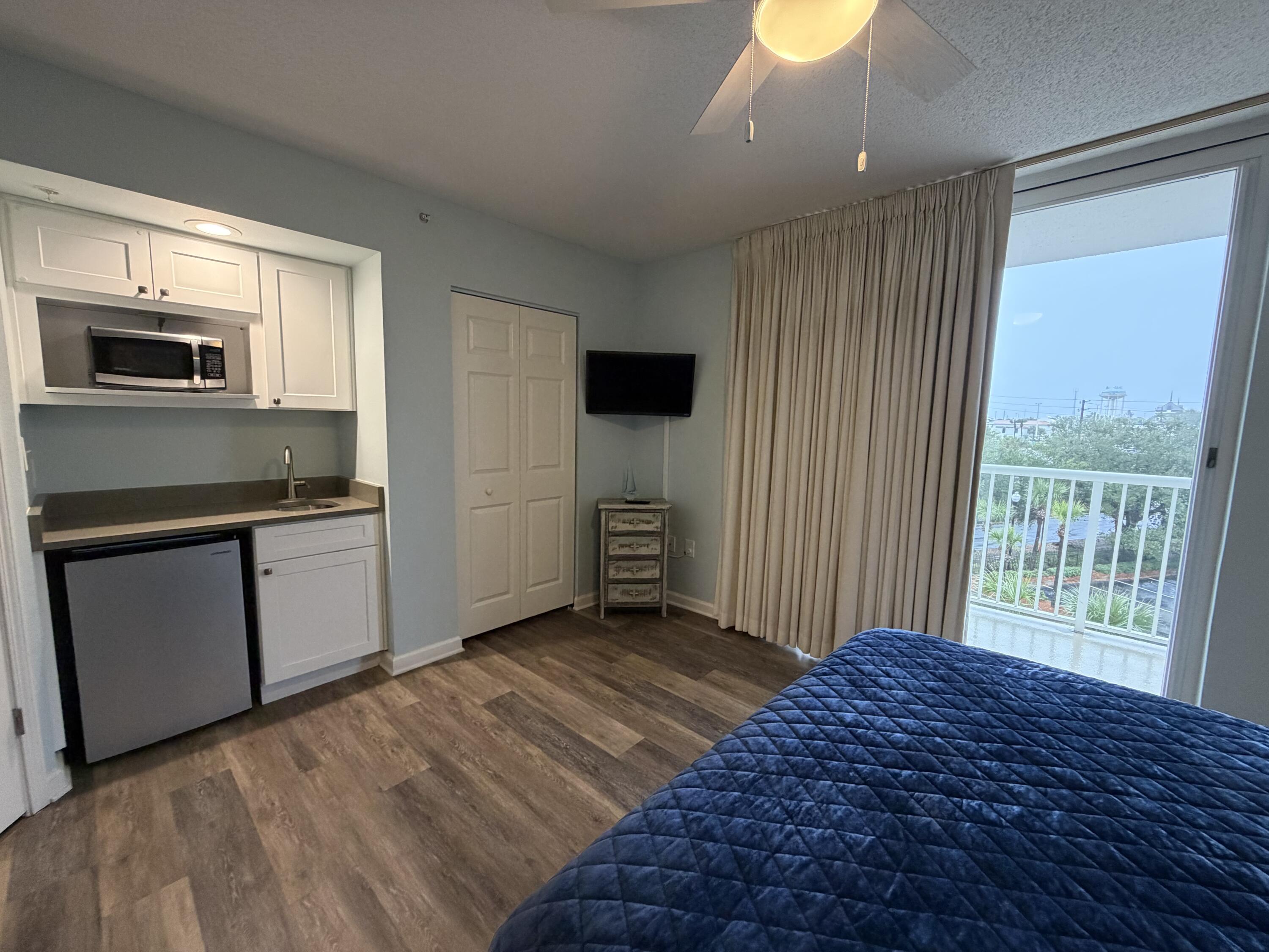 970 Highway 98, Unit 301 Destin, FL 32541 - Photo 14 of 18 a bedroom with a bed and a television