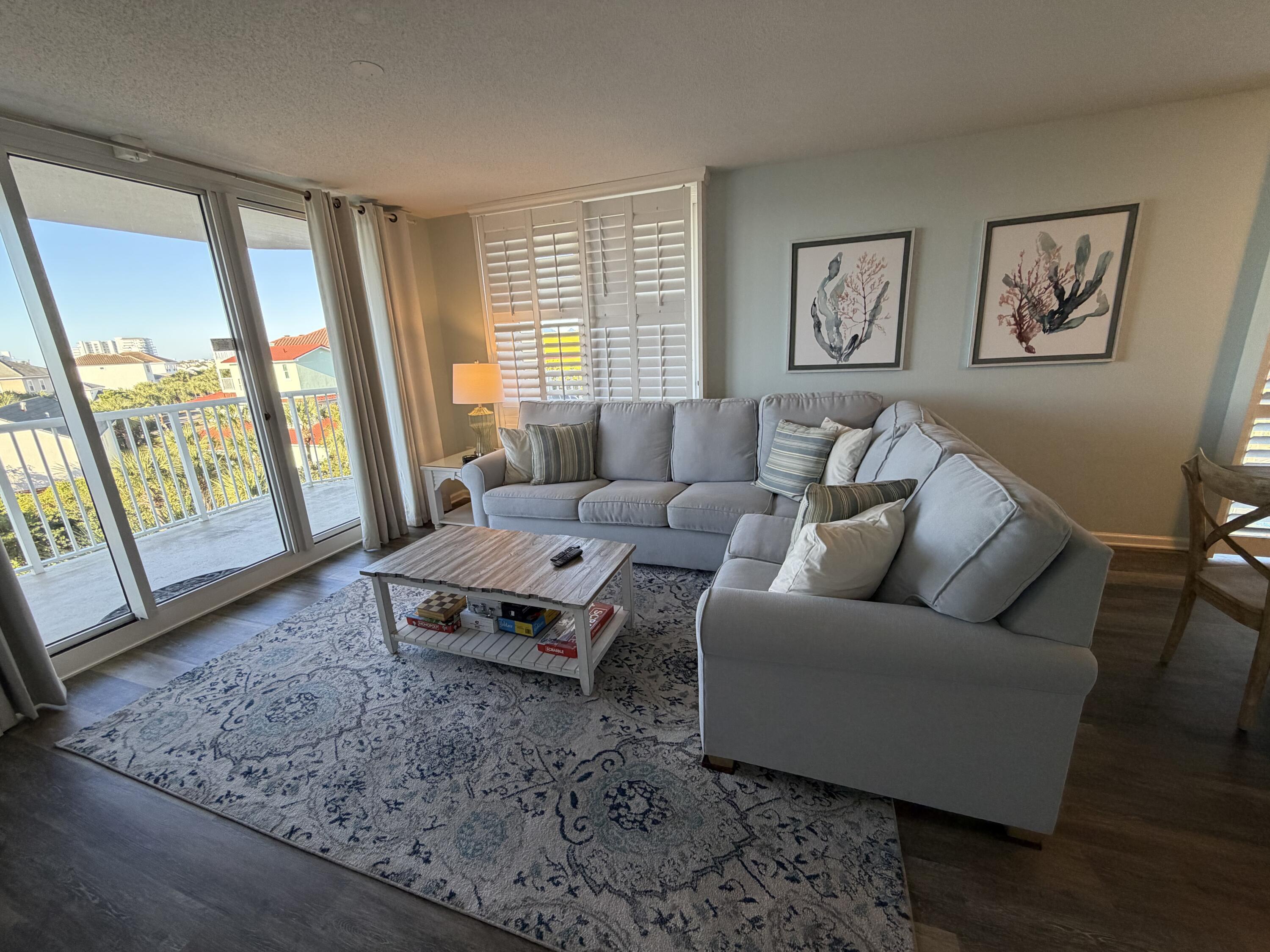 970 Highway 98, Unit 301 Destin, FL 32541 - Photo 4 of 18 a living room with furniture and large window with wooden floor