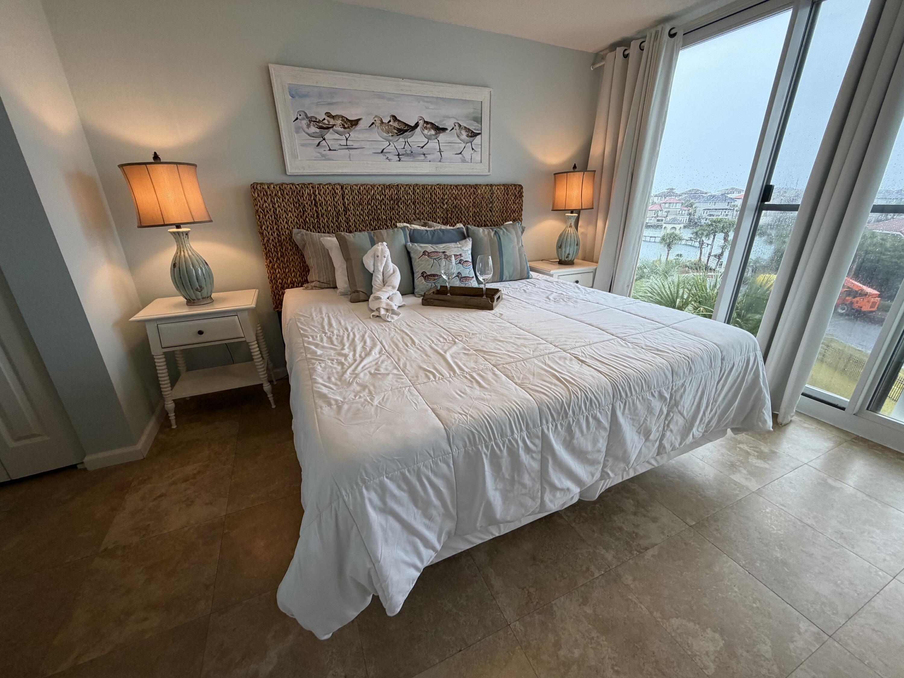 970 Highway 98, Unit 301 Destin, FL 32541 - Photo 8 of 18 a bed sitting in a bedroom next to a window