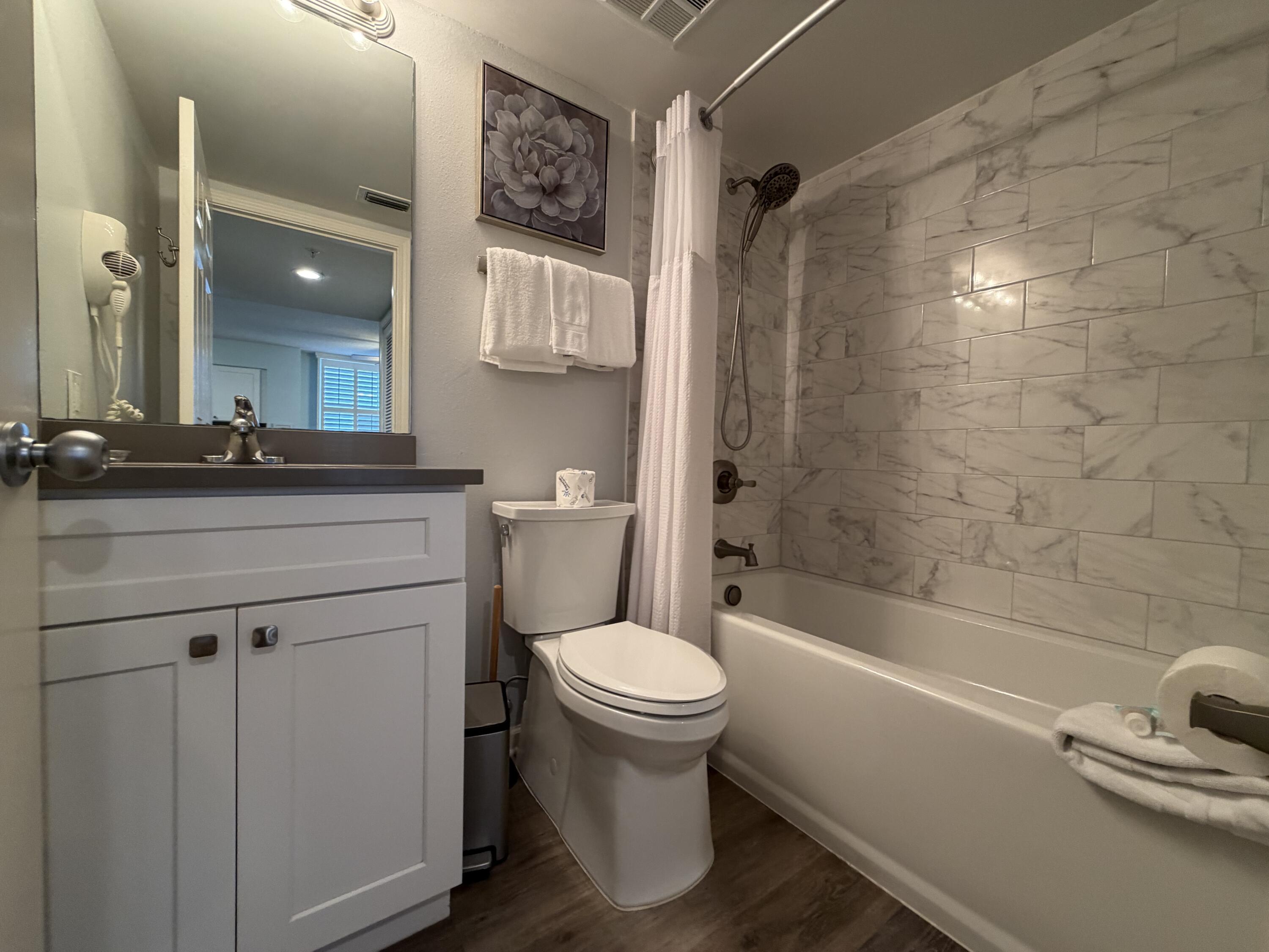 970 Highway 98, Unit 301 Destin, FL 32541 - Photo 10 of 18 a bathroom with a sink toilet and shower