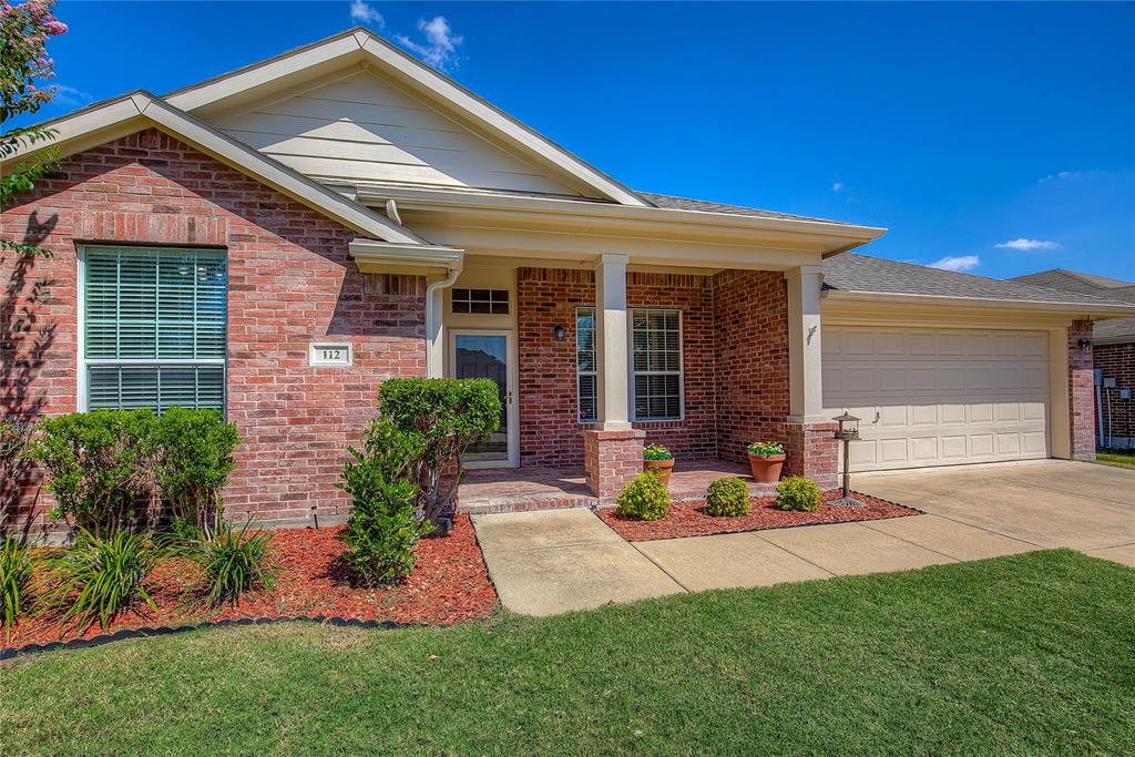 View of front of house with a front lawn and a garage