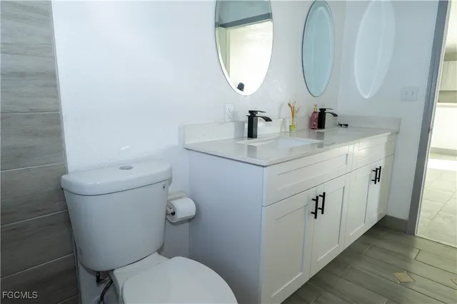 a bathroom with a toilet sink and mirror