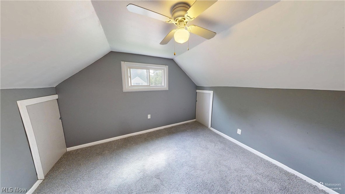 4174 Burkey Road Austintown, OH 44515 - Photo 15 of 33 Carpeted room featuring a ceiling fan with integrated lighting, a window, and two small built-in doors