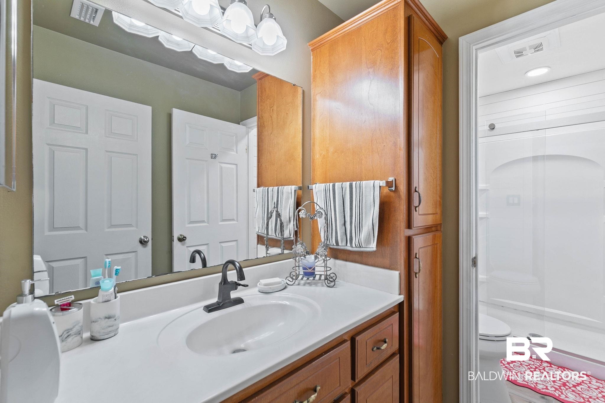 1510 South Juniper Street Foley, AL 36535 - Photo 21 of 36 Bathroom with vanity and a stall shower