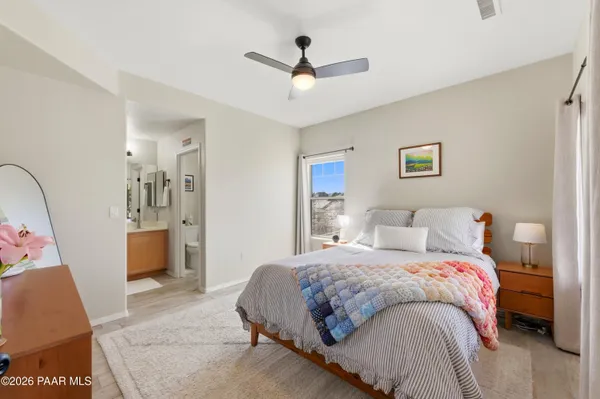 a bedroom with a large bed and a chandelier