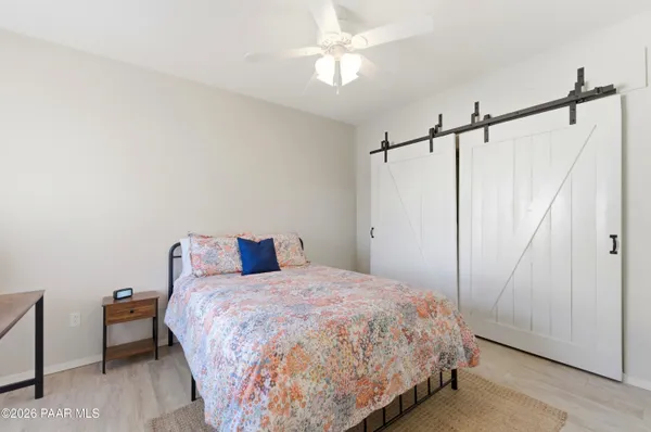 a bedroom with a bed and a ceiling fan