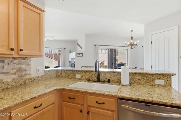a kitchen with sink and mirror