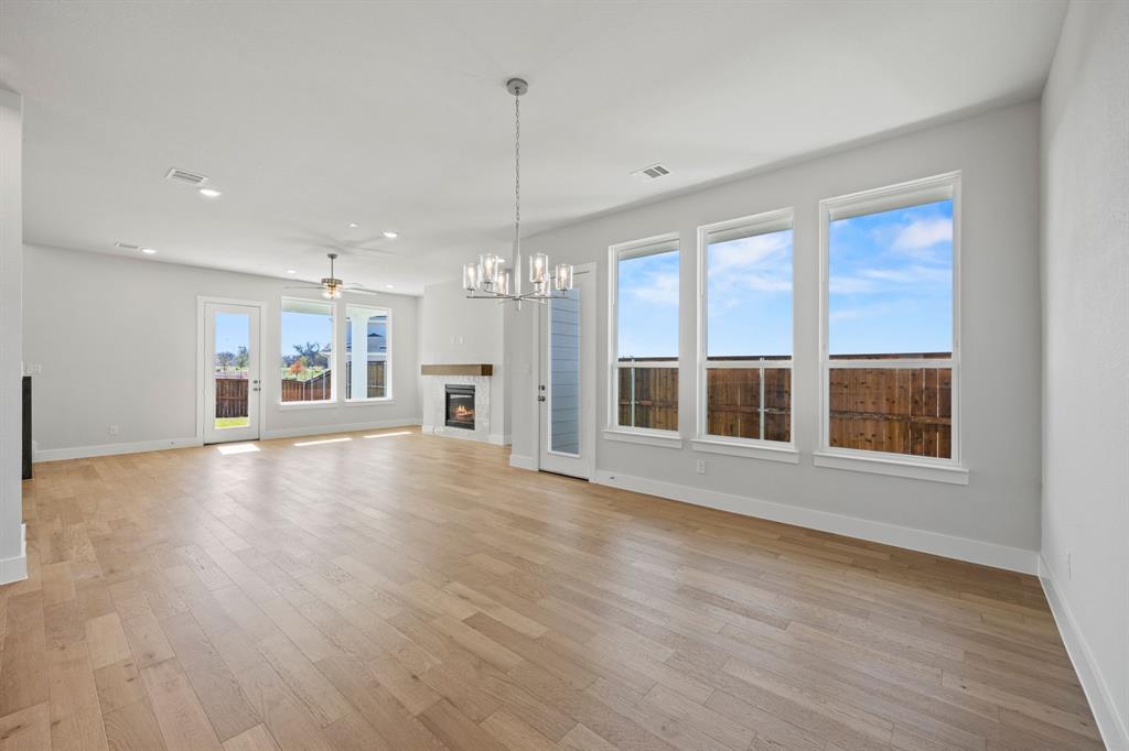505 Callum Parkway Celina, TX 75009 - Photo 13 of 34 a view of an empty room with a window and wooden floor