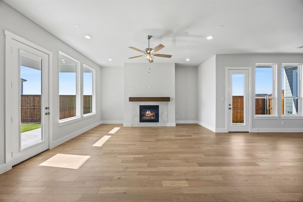 505 Callum Parkway Celina, TX 75009 - Photo 17 of 34 a view of an empty room with a fireplace and a window