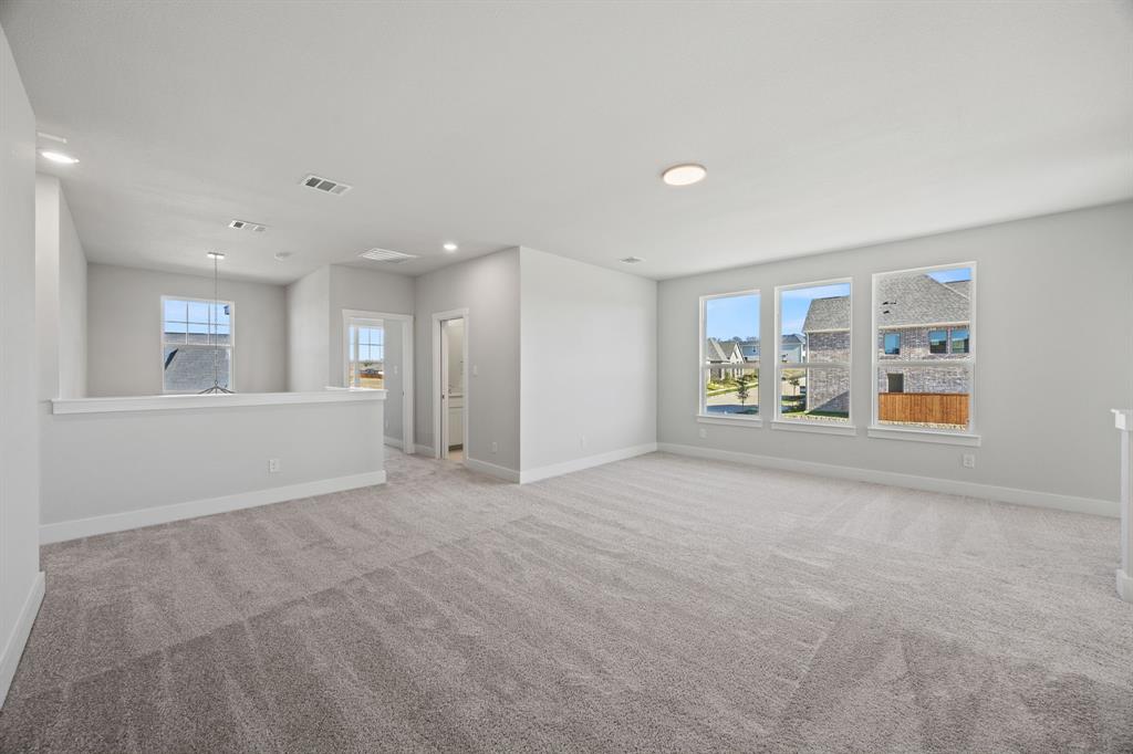 505 Callum Parkway Celina, TX 75009 - Photo 21 of 34 a view of a livingroom with wooden floor and a rug