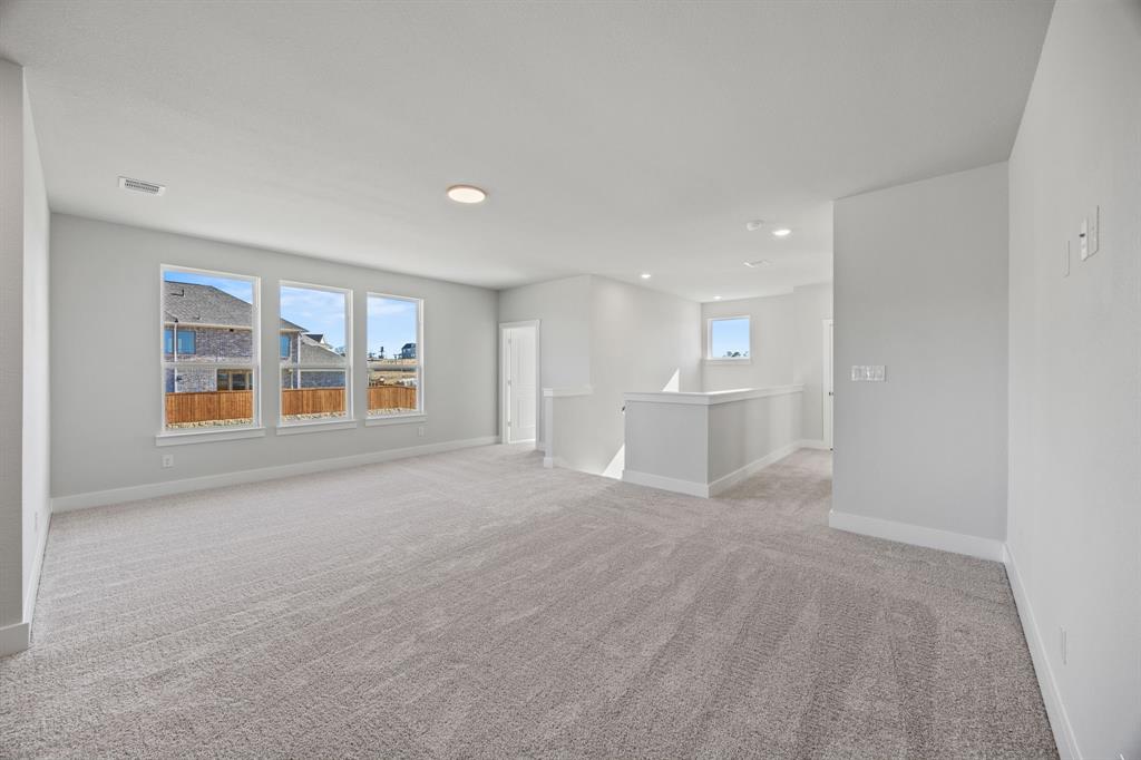 505 Callum Parkway Celina, TX 75009 - Photo 22 of 34 a view of an empty room with a window and wooden floor