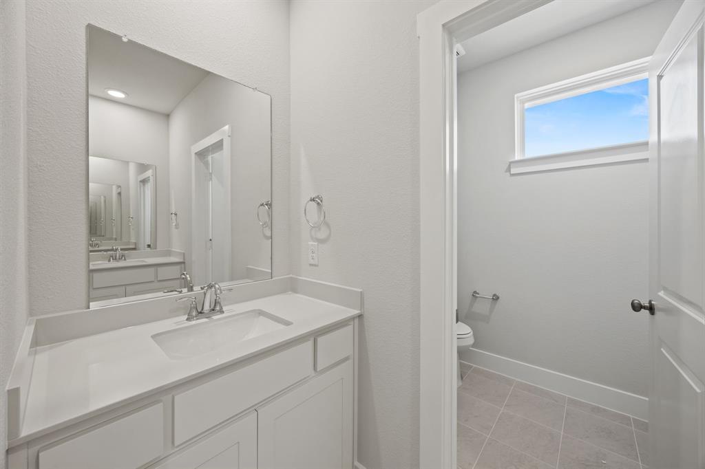 505 Callum Parkway Celina, TX 75009 - Photo 24 of 34 a bathroom with a sink and a mirror