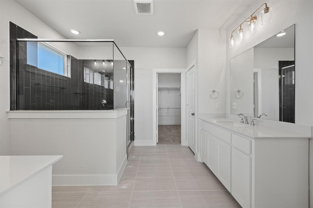 505 Callum Parkway Celina, TX 75009 - Photo 29 of 34 a bathroom with a double vanity sink and mirror