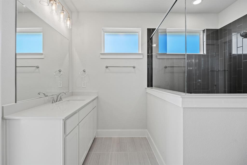 505 Callum Parkway Celina, TX 75009 - Photo 31 of 34 a bathroom with a sink and mirror