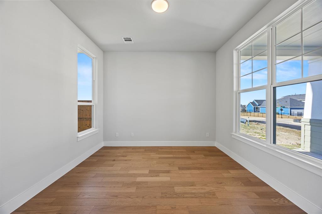505 Callum Parkway Celina, TX 75009 - Photo 5 of 34 wooden floor in an empty room with a window