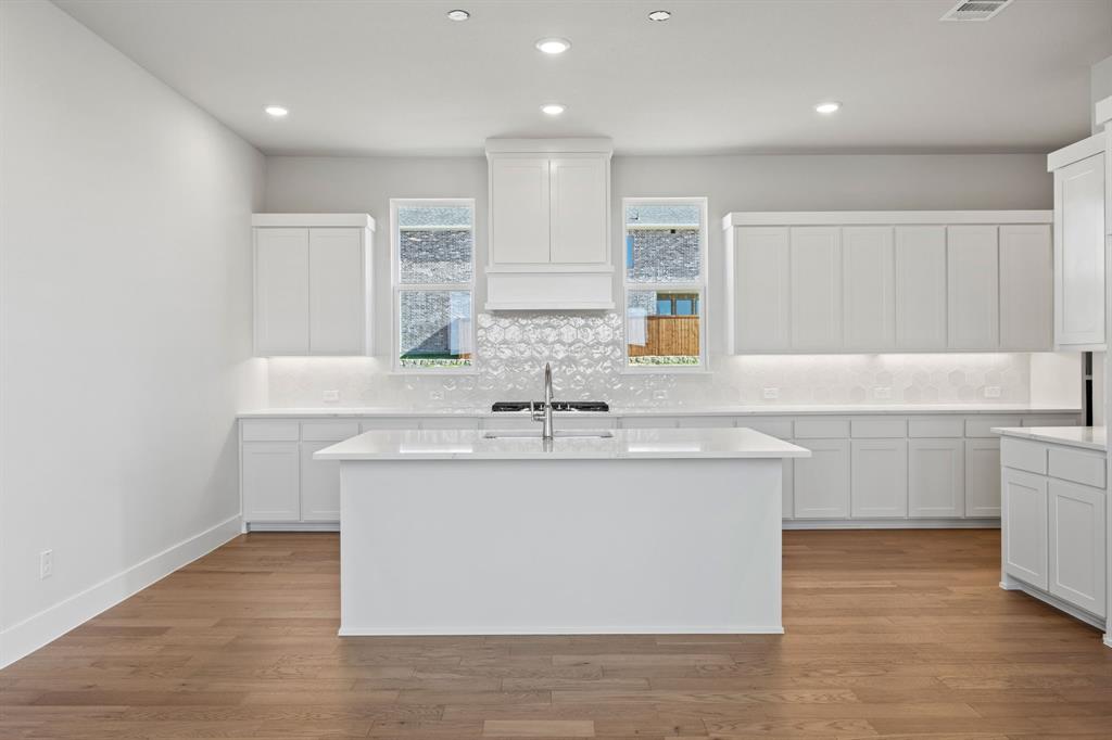 505 Callum Parkway Celina, TX 75009 - Photo 7 of 34 a bathroom with a granite countertop sink a large mirror and a