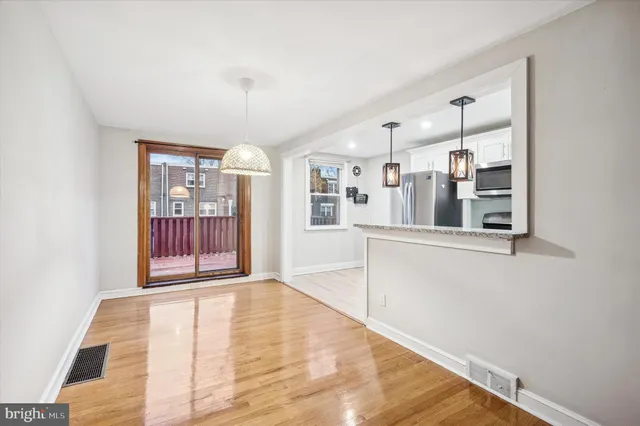 a view of an entryway with wooden floor
