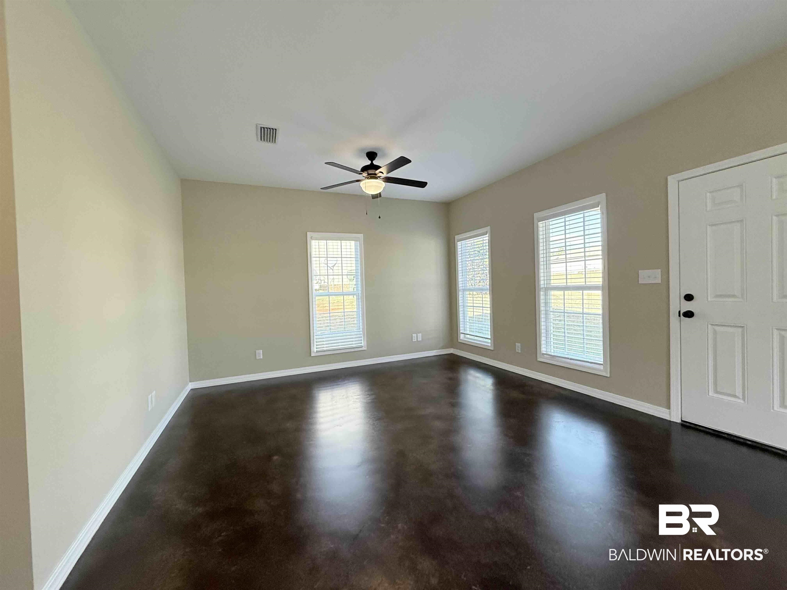33071 -B Stables Drive, Unit B Daphne, AL 36527 - Photo 4 of 13 Unfurnished room with healthy amount of natural light, concrete flooring, and ceiling fan