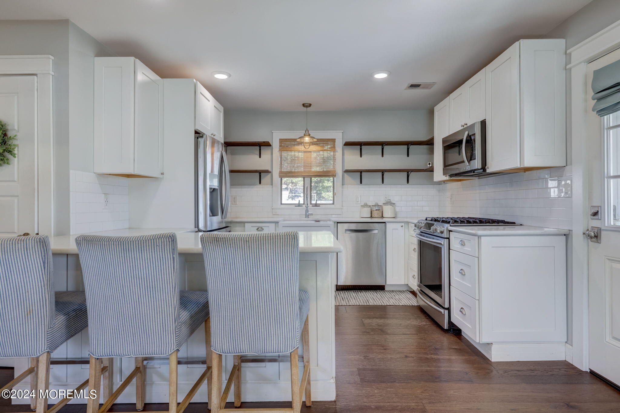 154 Ridge Avenue Belford, NJ 07718 - Photo 12 of 28 a kitchen with stainless steel appliances granite countertop a white cabinets and a stove top oven