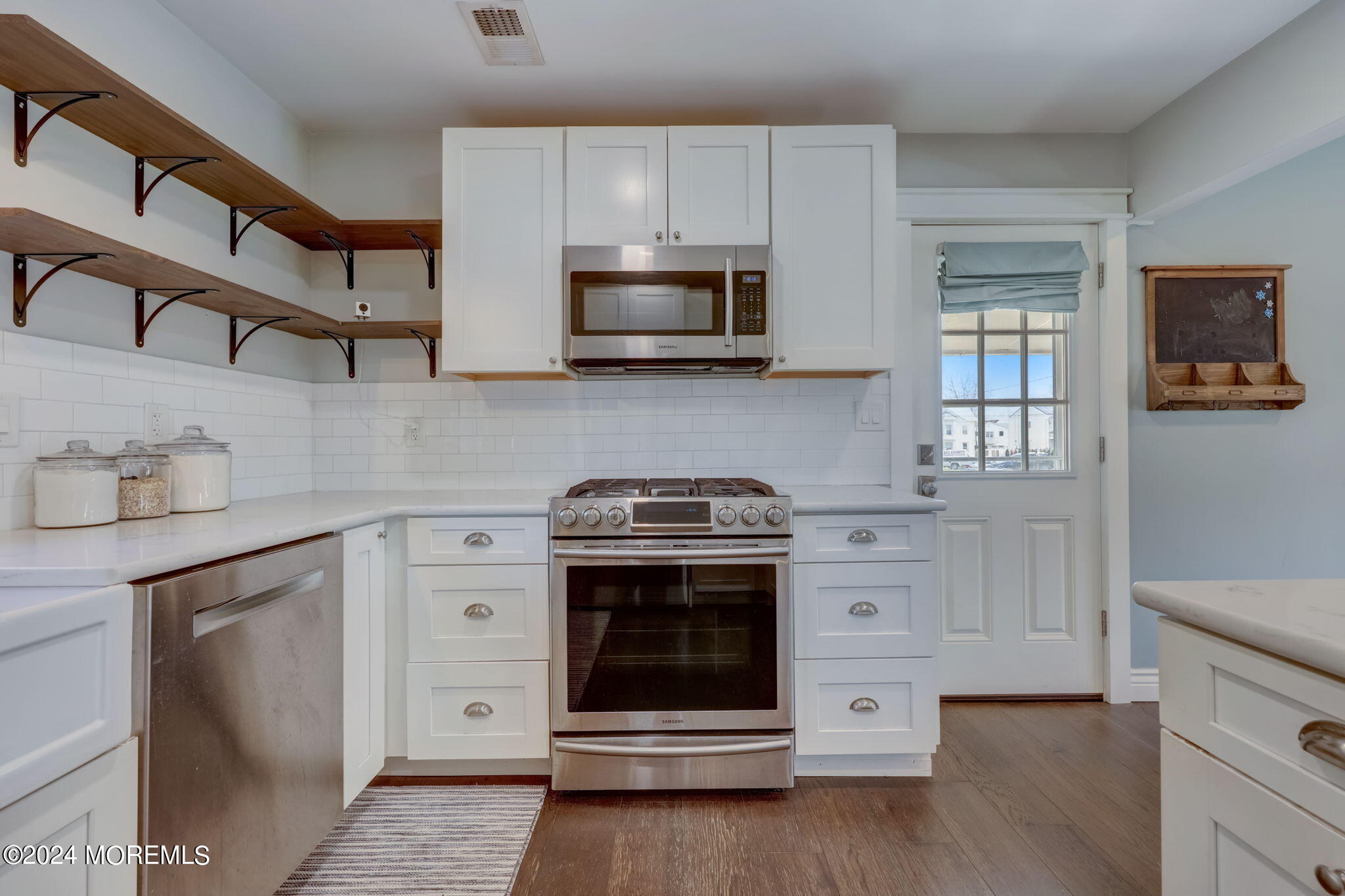 154 Ridge Avenue Belford, NJ 07718 - Photo 14 of 28 a kitchen with stainless steel appliances granite countertop a stove and a microwave