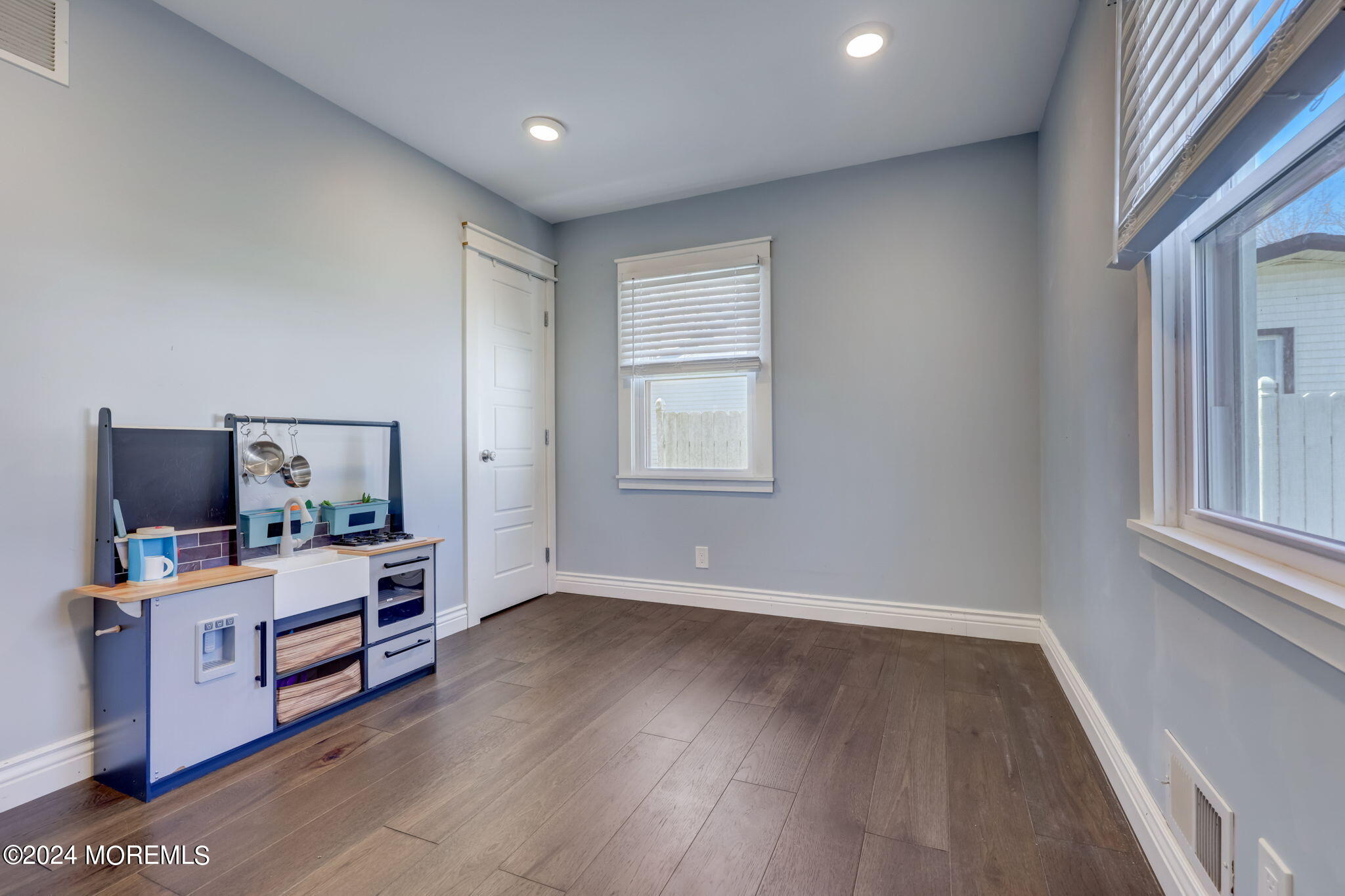 154 Ridge Avenue Belford, NJ 07718 - Photo 16 of 28 a room with a bed and wooden floor