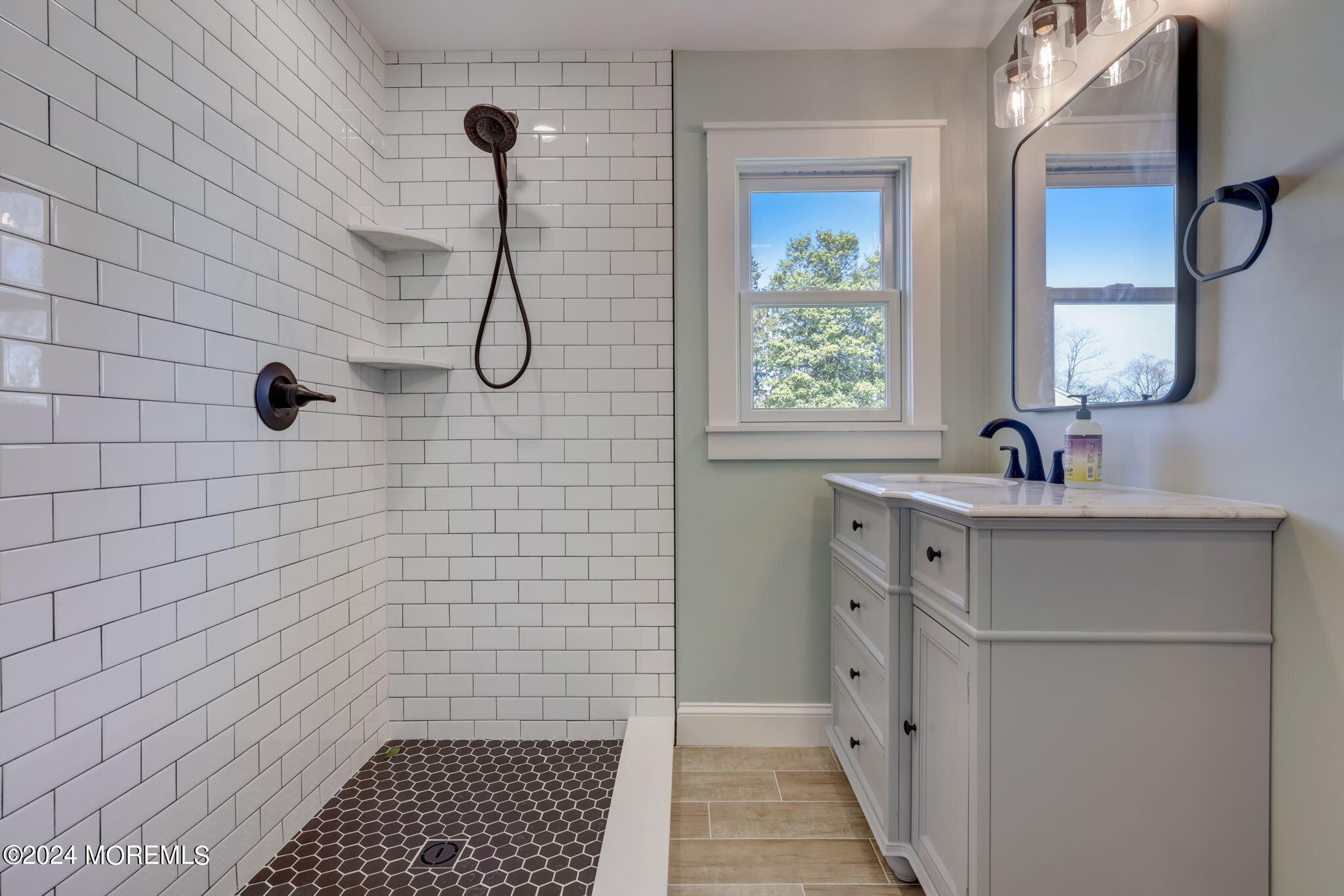 154 Ridge Avenue Belford, NJ 07718 - Photo 18 of 28 a bathroom with a sink a toilet a window and vanity
