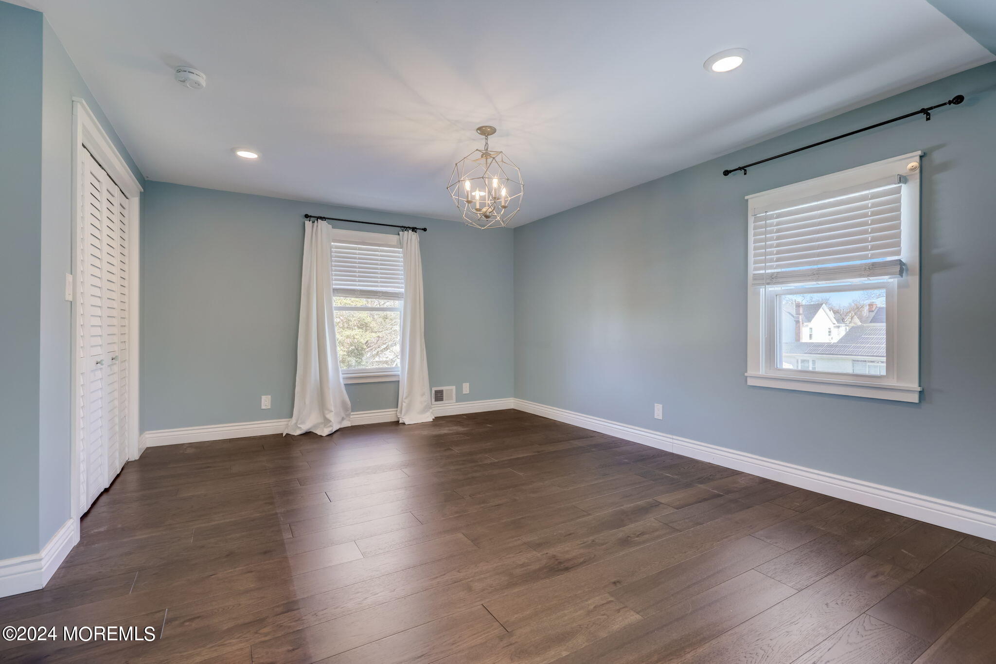 154 Ridge Avenue Belford, NJ 07718 - Photo 19 of 28 an empty room with wooden floor chandelier and windows