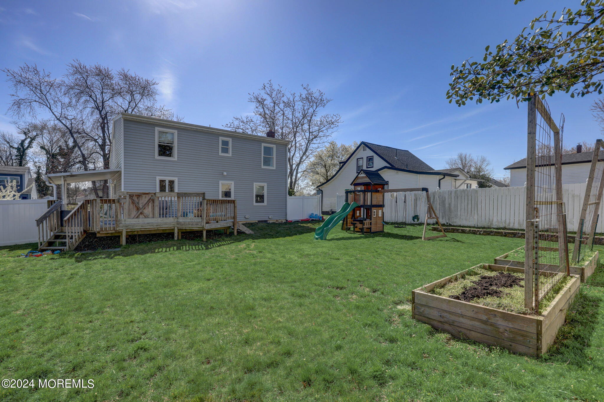 154 Ridge Avenue Belford, NJ 07718 - Photo 27 of 28 a view of a house with backyard and a tree