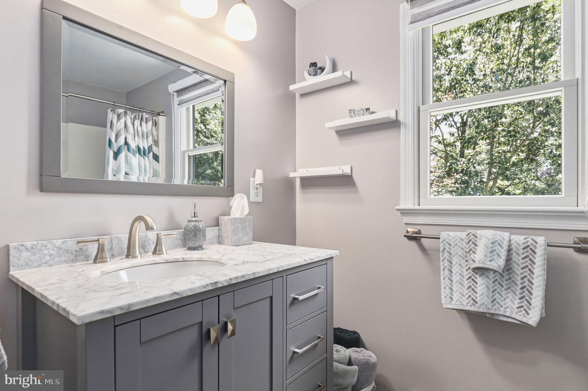 6336 Boyers Mill Road New Market, MD 21774 - Photo 19 of 49 a bathroom with a granite countertop sink and a window