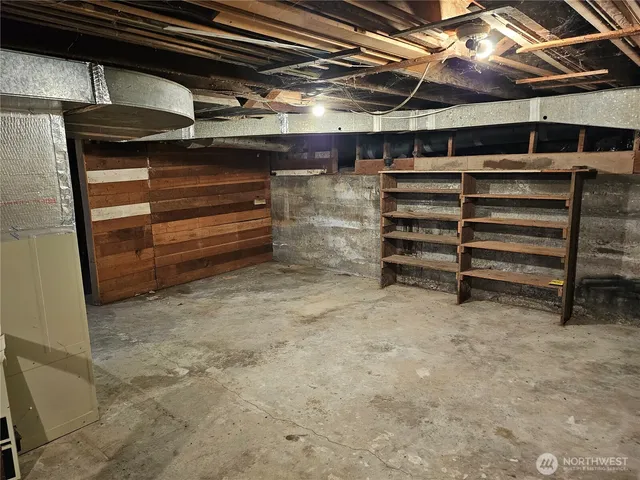 an empty room with windows and a fireplace