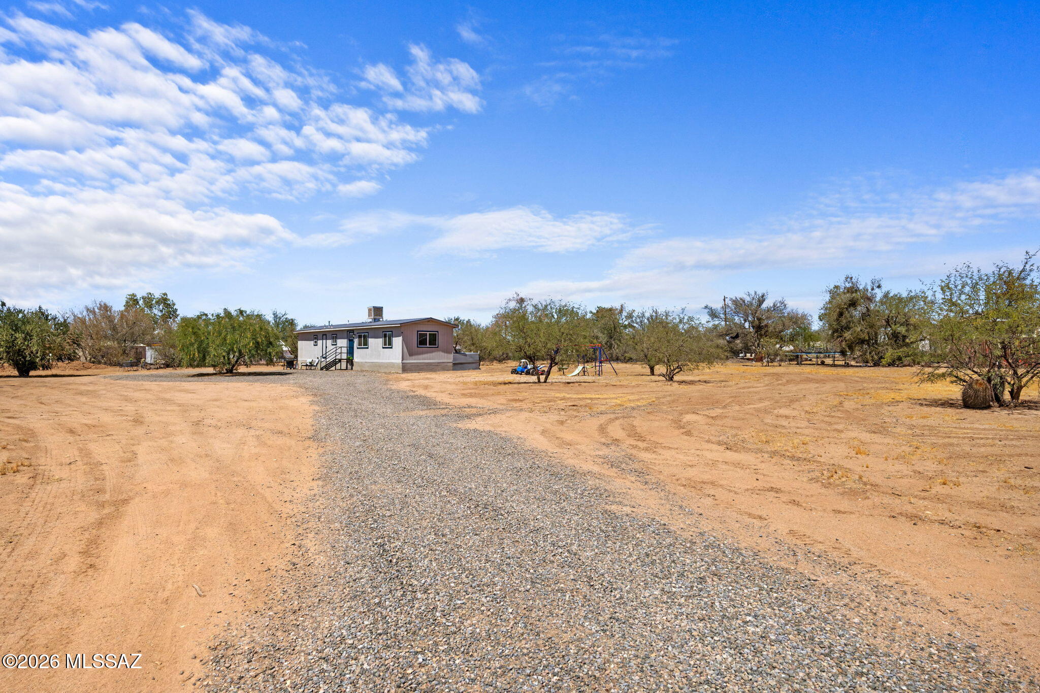 13140 West El Lobo Road Tucson, AZ 85743 - Photo 3 of 30 The private gated driveway leads to the home, offering ample parking.