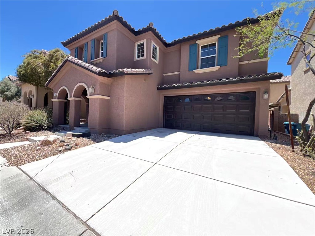 11143 Ranch Valley Street Las Vegas, NV 89179 - Photo 2 of 23 A well-maintained stucco home offers a two-car garage and a welcoming arched entry.